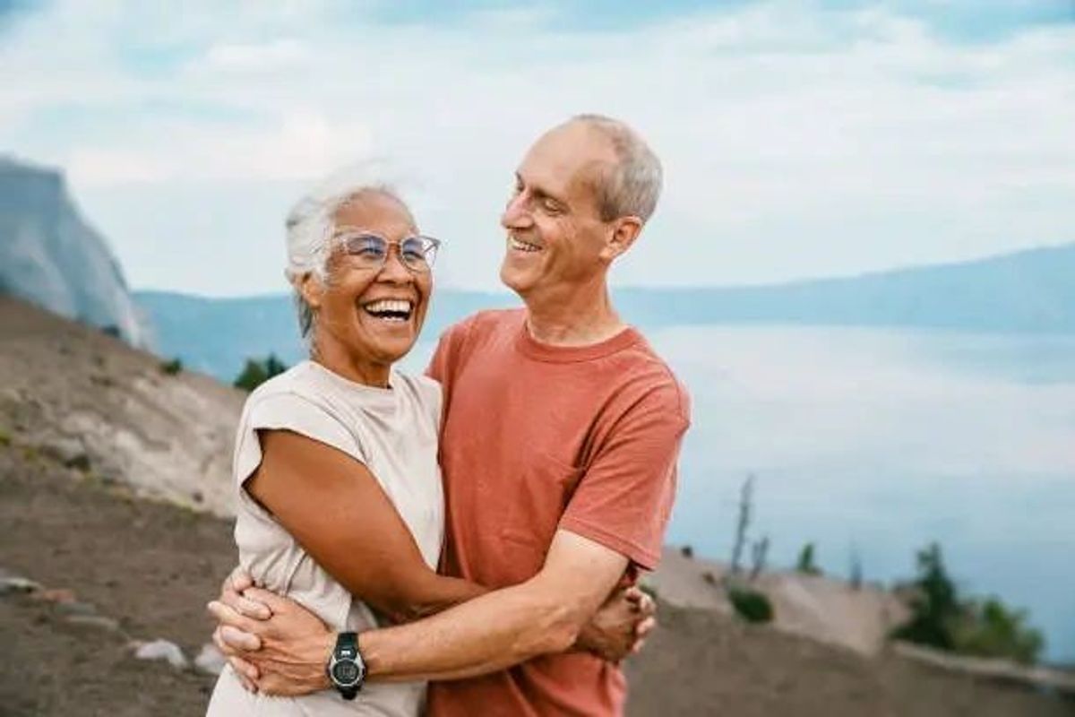Retired couple smiling at lake