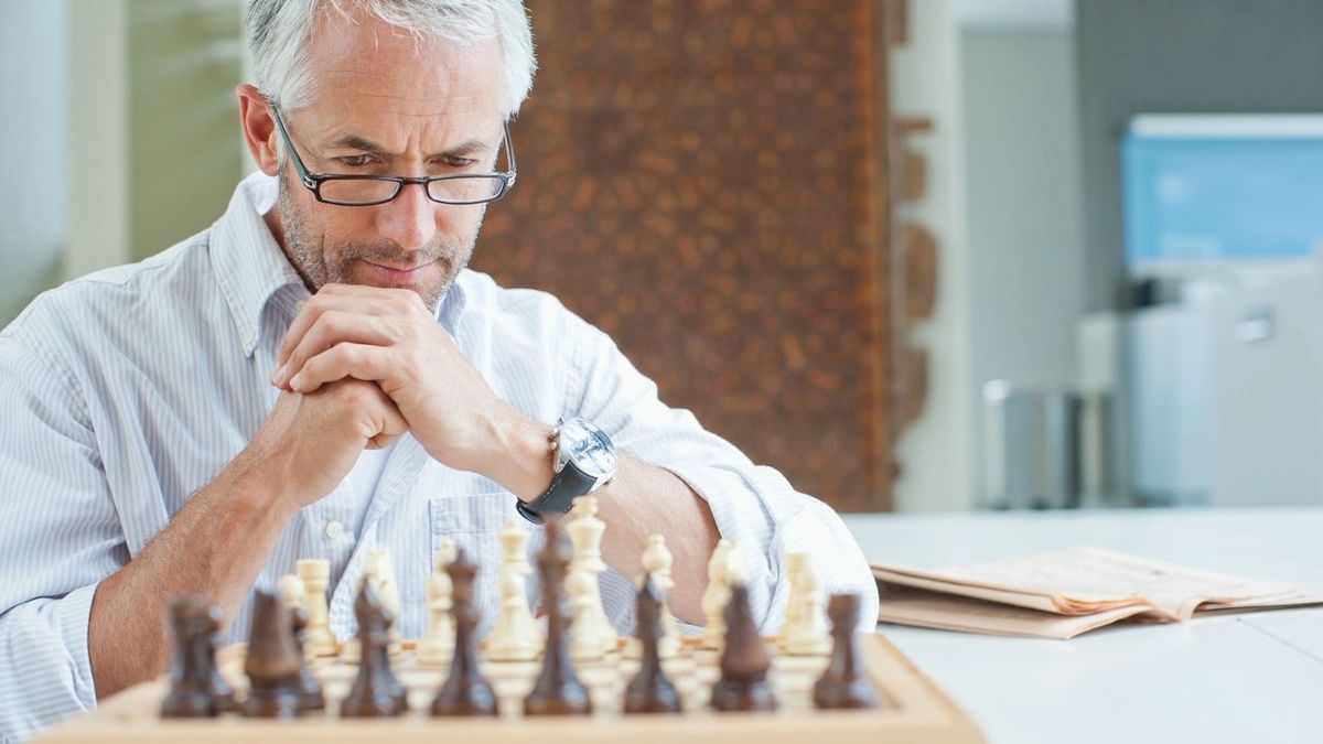 Retiree looking at a chess board