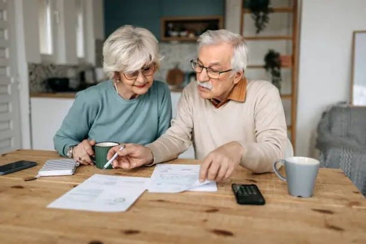 Retired couple reviewing 401(k) and retirement income decisions at home
