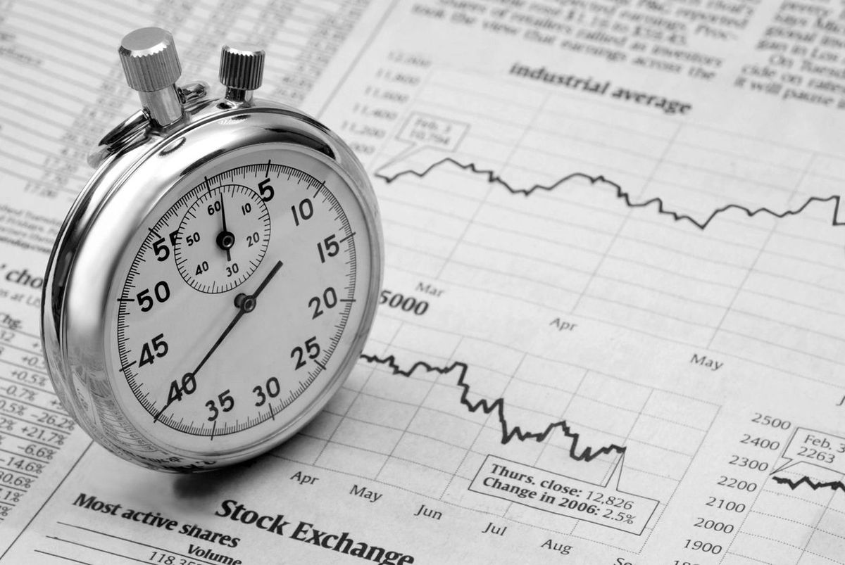 Stopwatch on a stock exchange newspaper