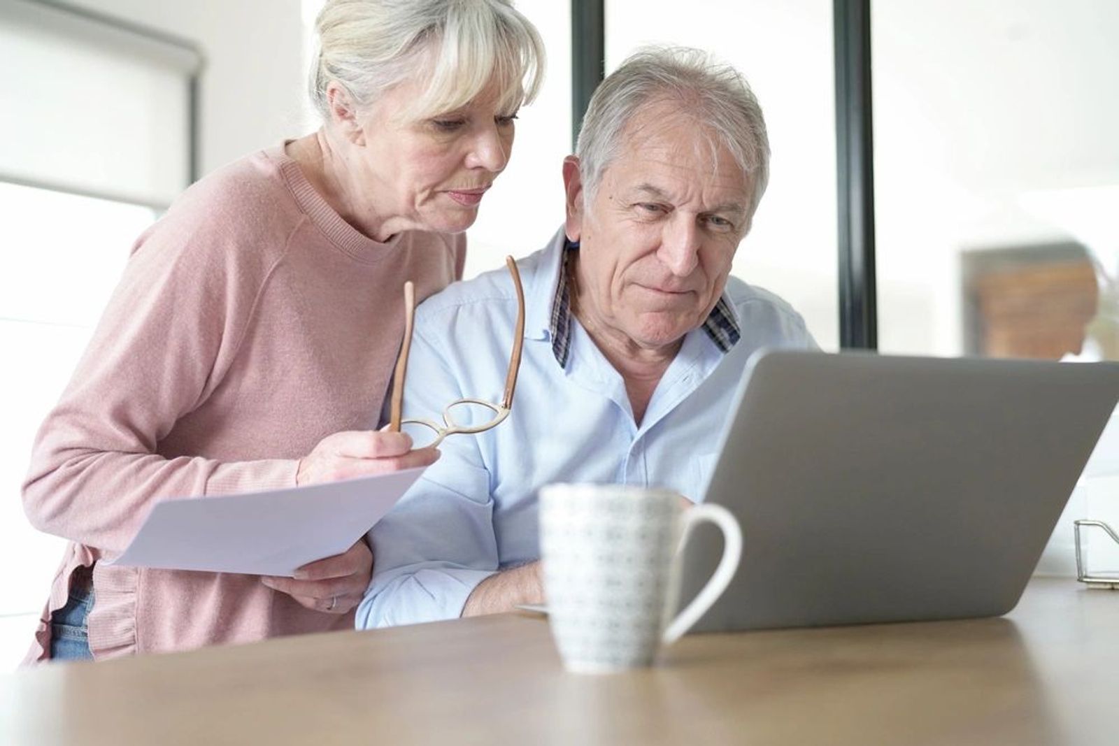 Retired couple planning finances at kitchen table