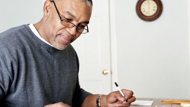 Retiree adding up bills