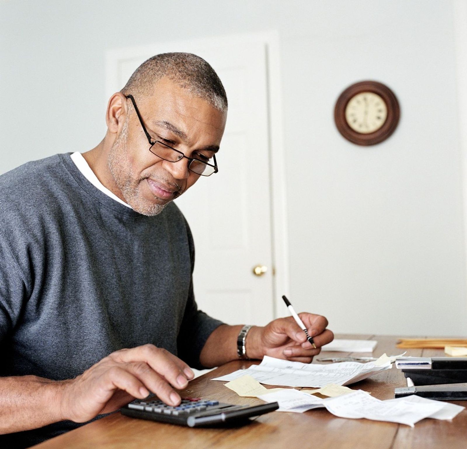 Retiree adding up bills