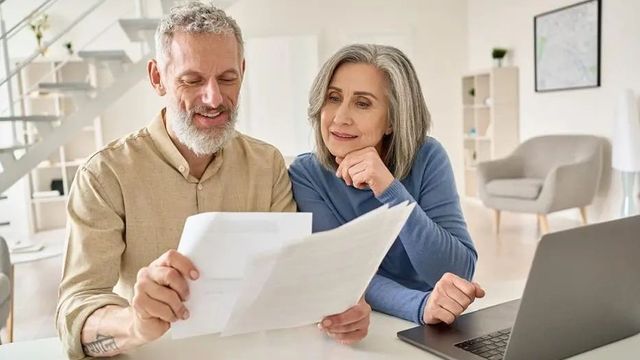 Old financial couple looking at plan
