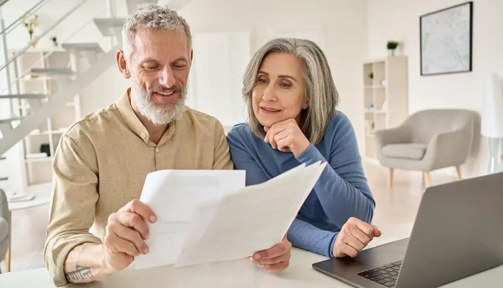 Old financial couple looking at plan
