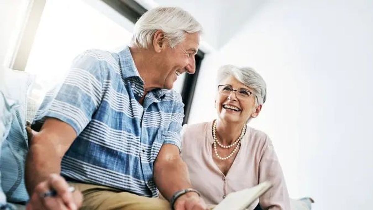 Older retired couple planning finances smiling