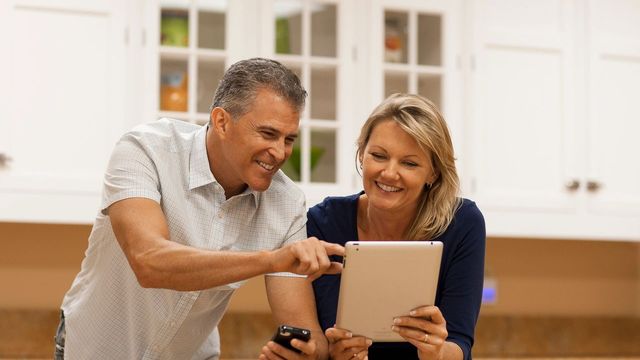 Retired couple calculating at dinner table