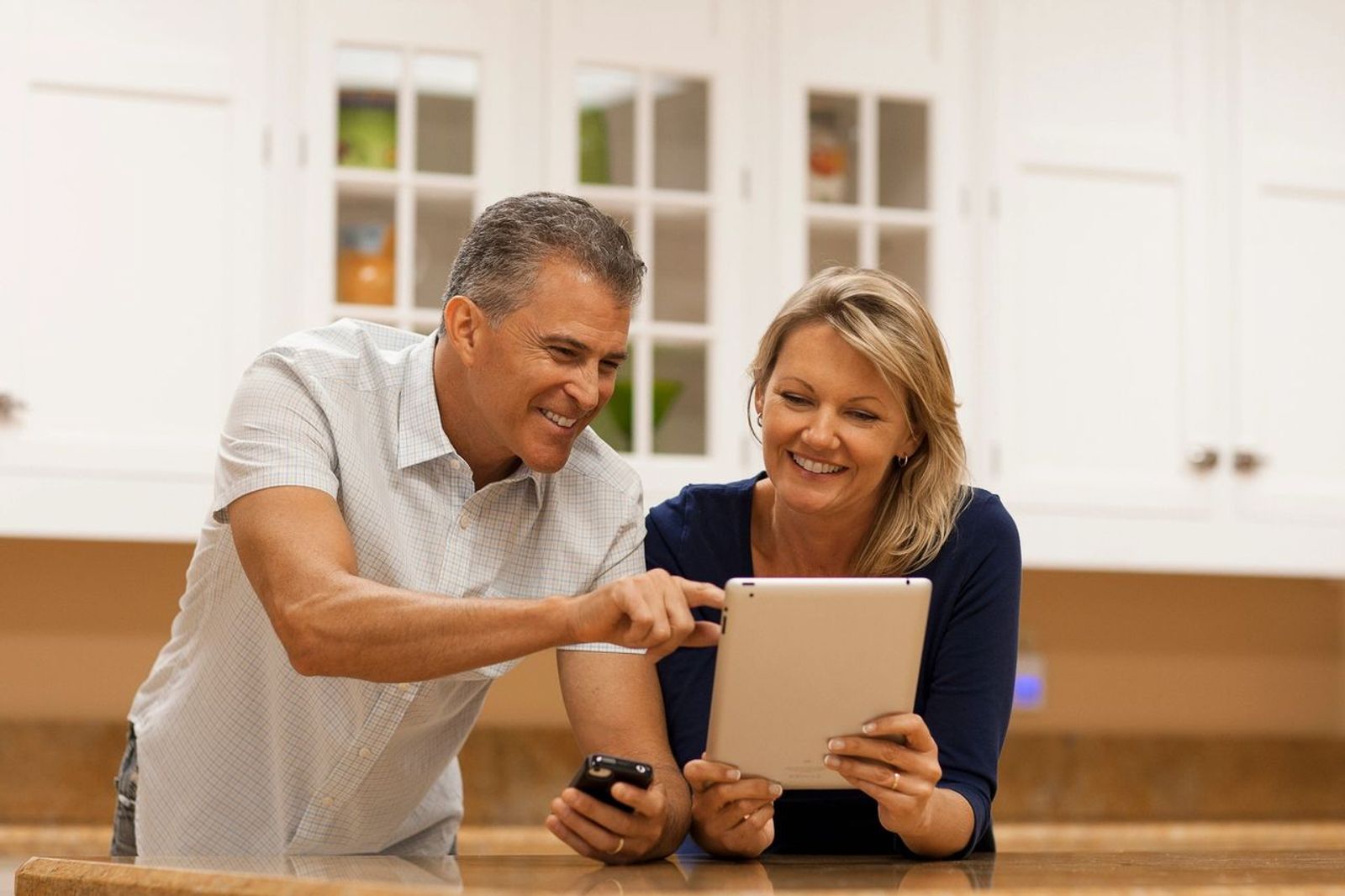 Retired couple calculating at dinner table
