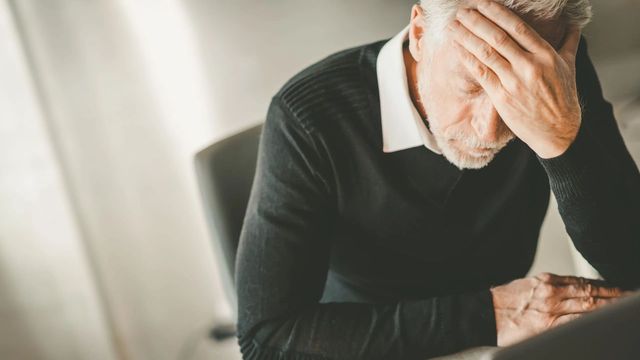 Retiree stressed out about finances in a chair