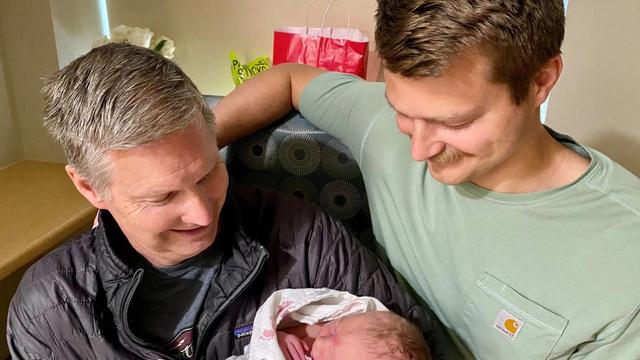 Grandfather, and father holding newborn