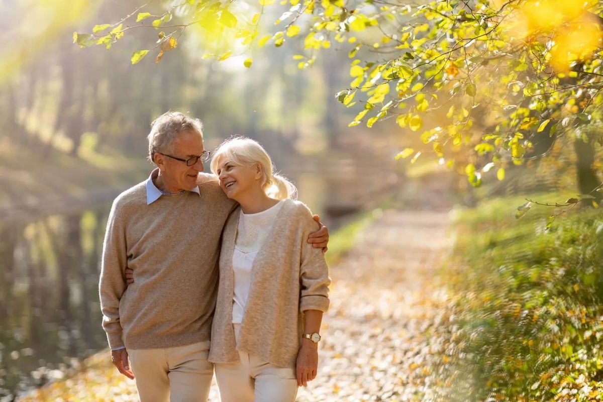 retired couple walking through the woods