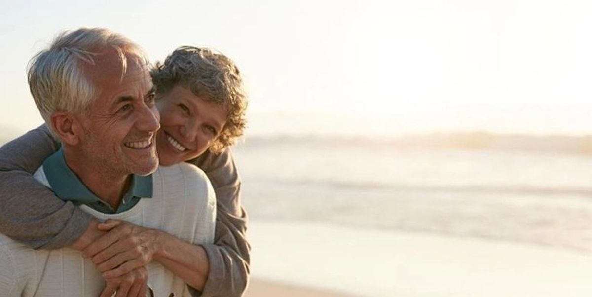retired couple smiling at beach