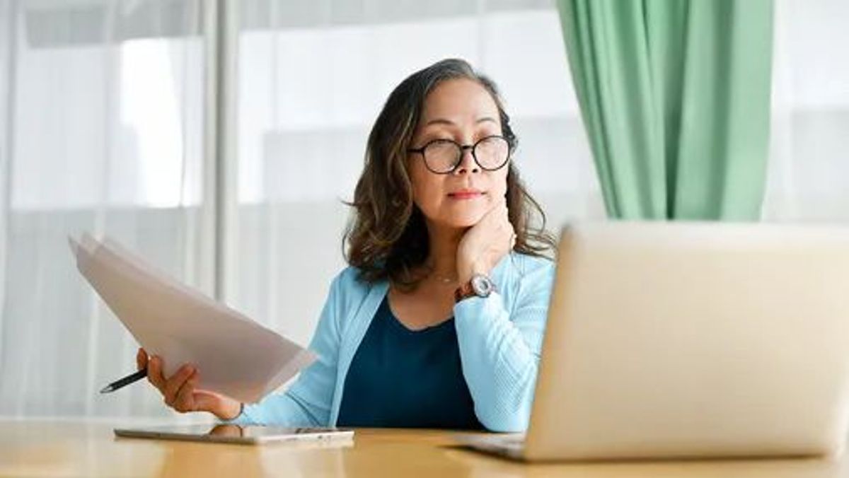 Older professional reviewing Medicare and employer health coverage options