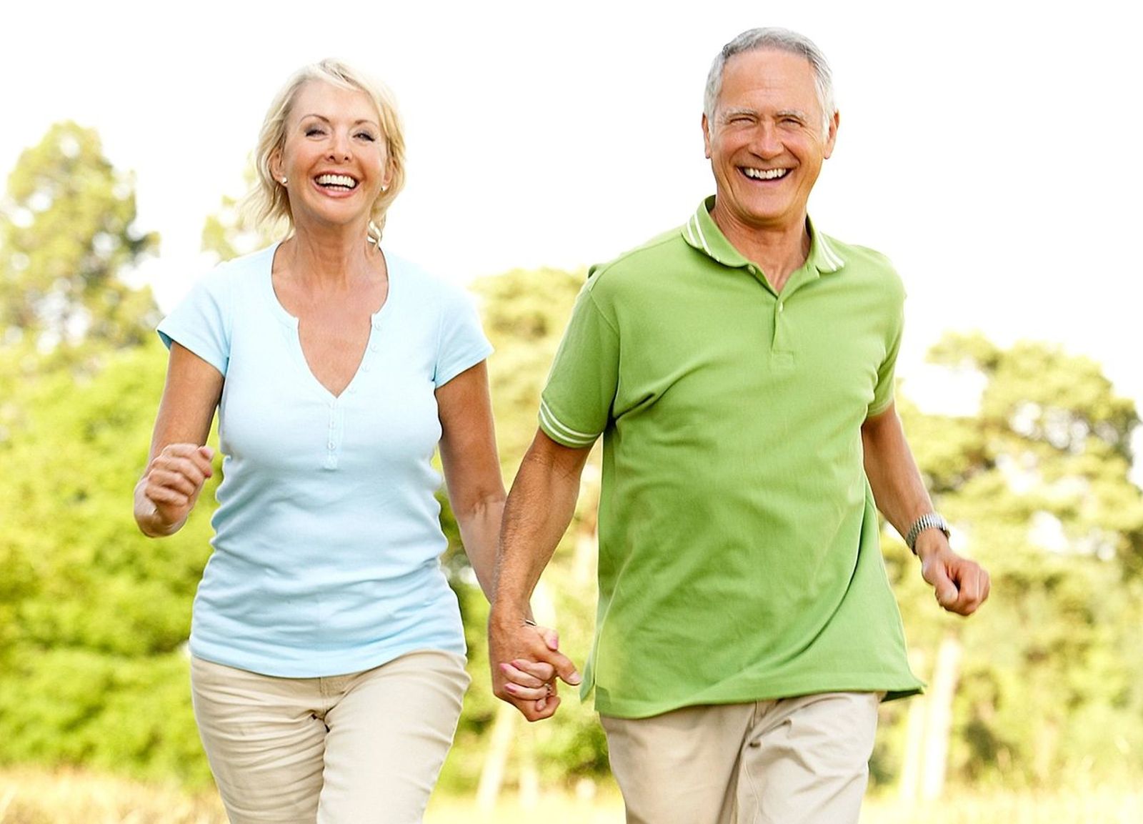 Retired couple  smiling while running