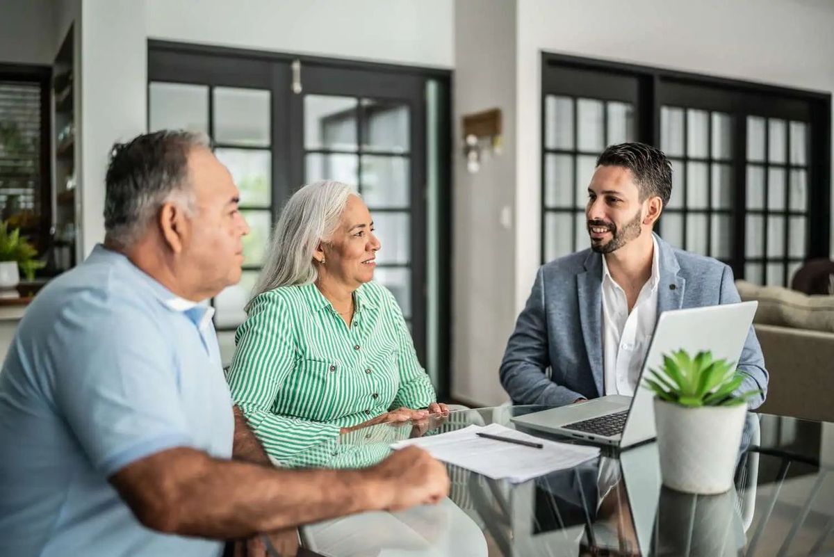 Financial advisor meeting with retirees to discuss inherited IRA rules and financial planning