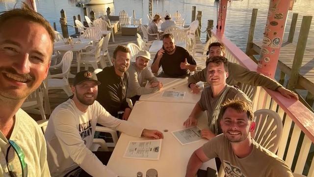 Friends having dinner on a Bahama dock