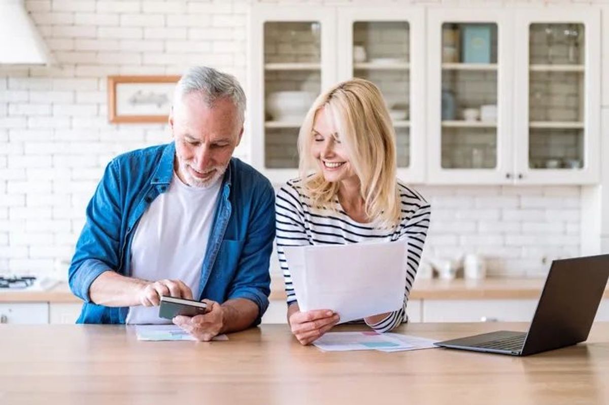 Retired couple calculate at kitchen table