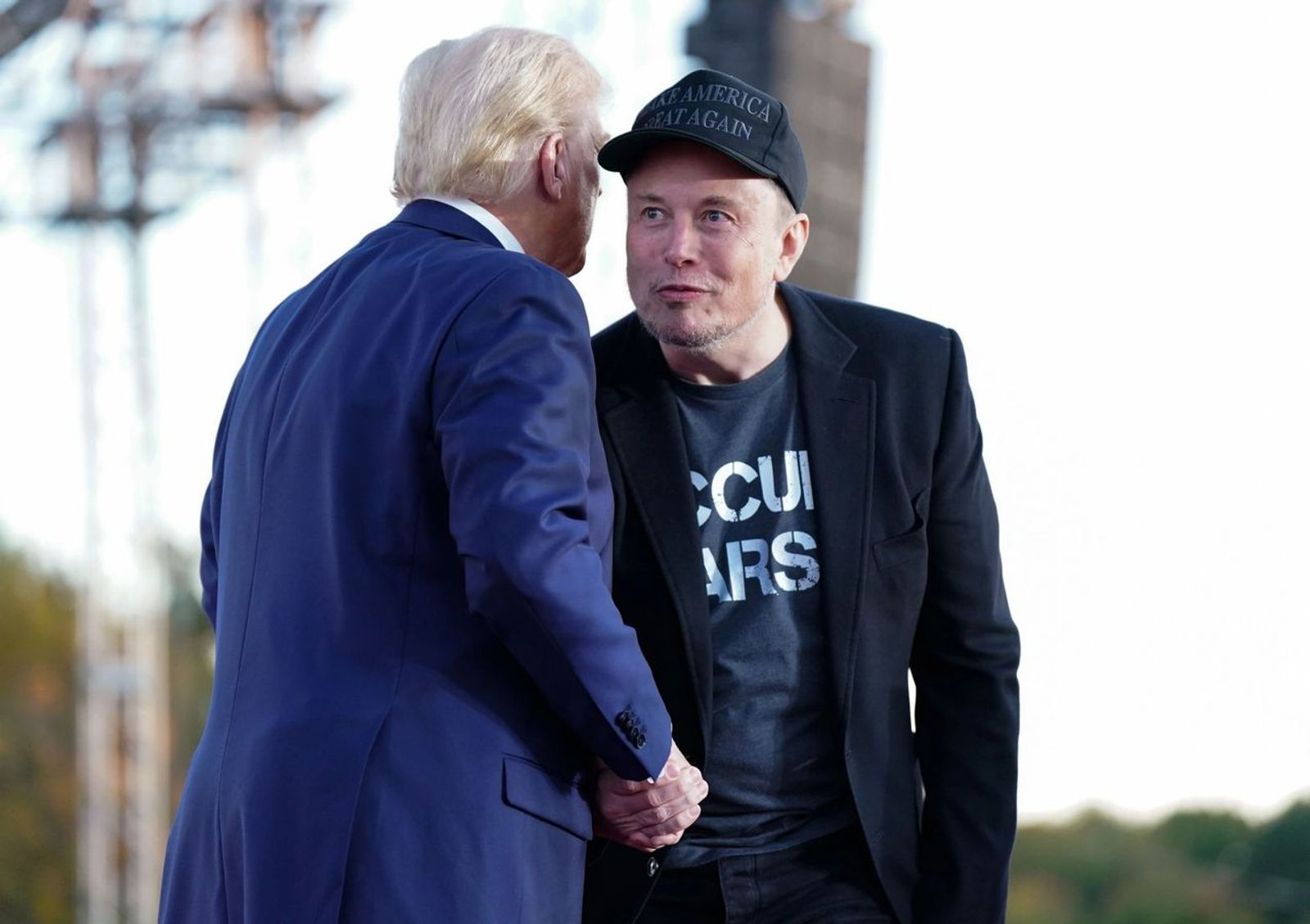 Elon Musk and Donald Trump shaking hands