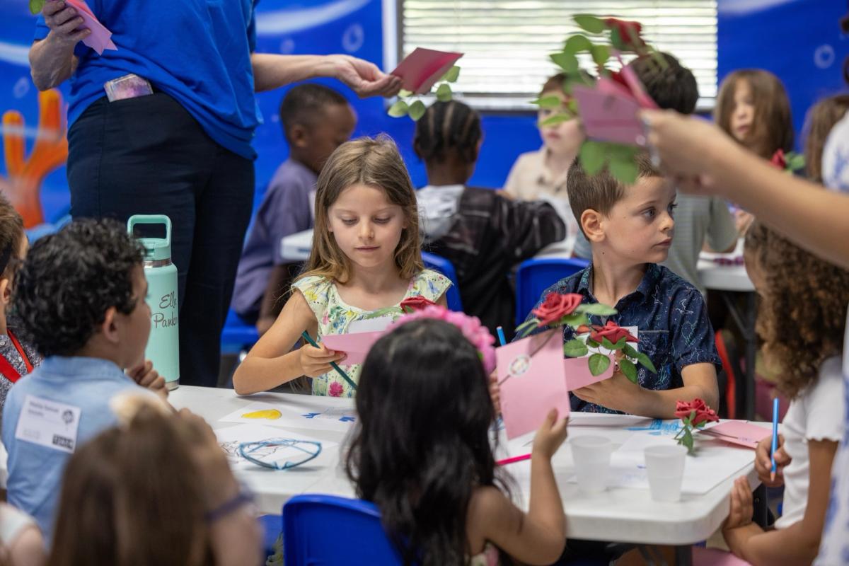 Children making crafts at a table