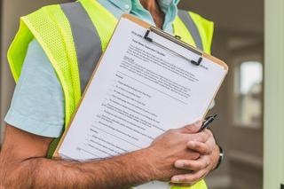 Project safety manager conducting jobsite compliance inspection.
