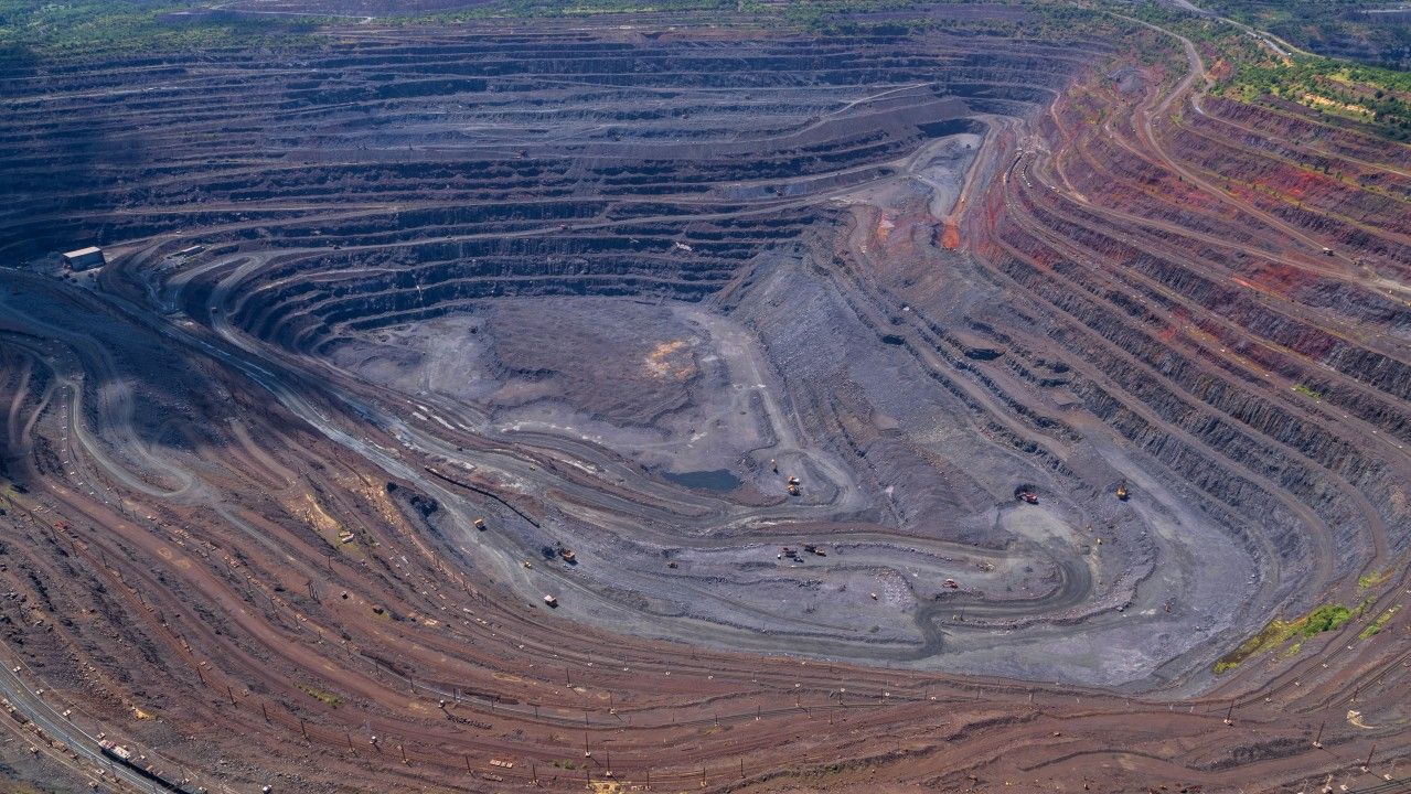 Mining safety signage and equipment at an open-pit site.