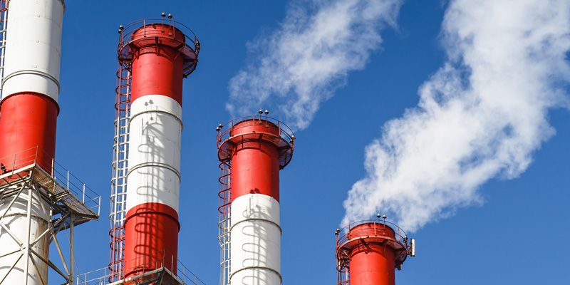 EHS team monitoring emissions data at chemical facility.