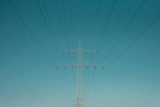 Energy power grid visible in the distance at the dawn