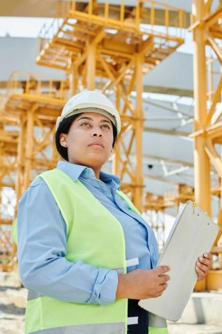 Worker using hearing protection in an industrial setting.