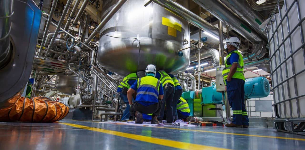EHS specialist conducting safety inspection in a manufacturing facility.