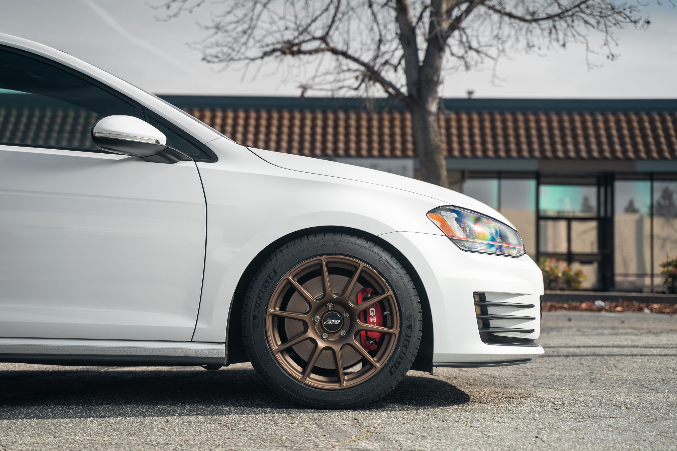 White VW MK7 GTI with 17" SM-10 Apex wheels in Satin Bronze