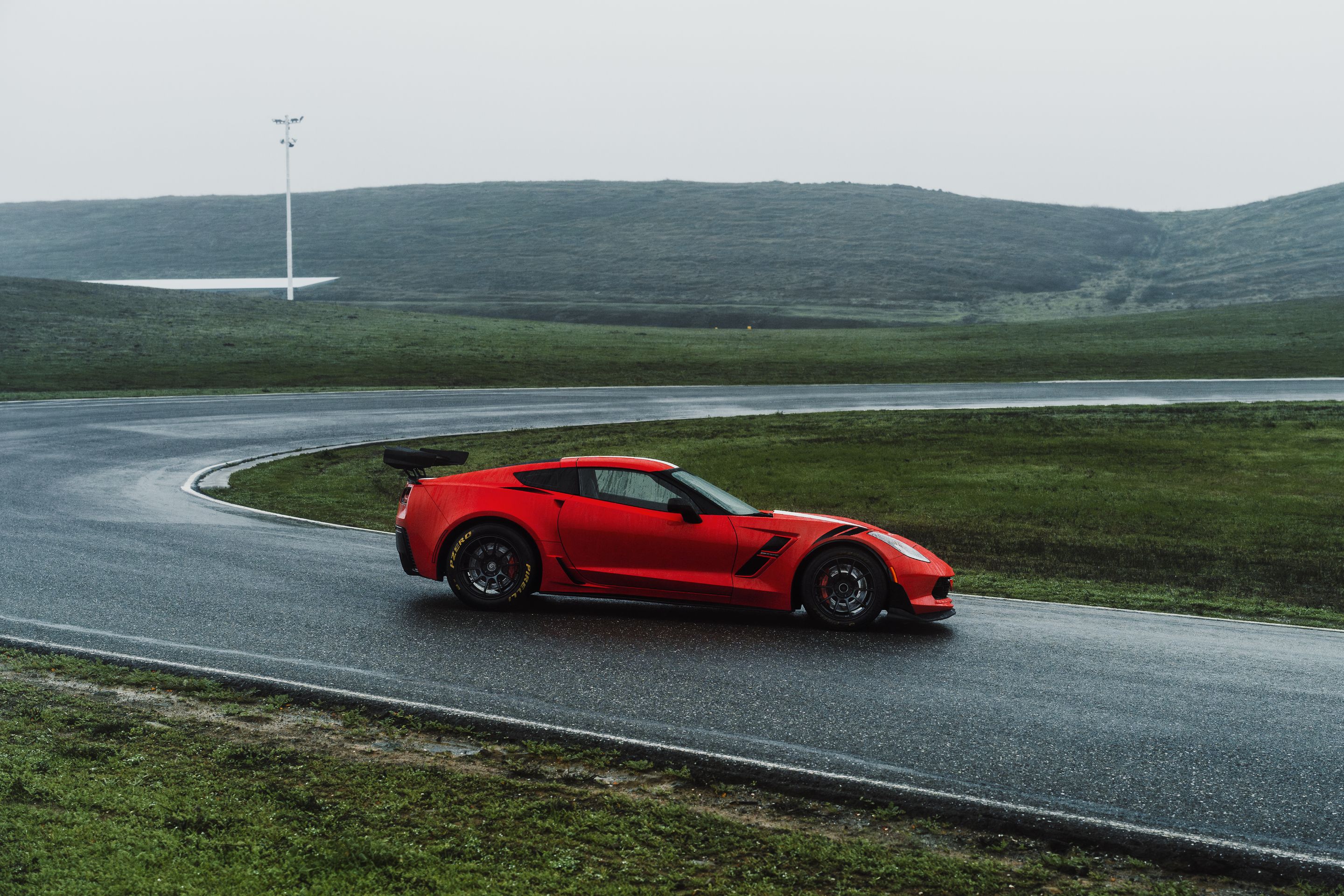 Red Chevrolet C7 Corvette Grand Sport with 18" SM-10RE Apex wheels in Satin Black