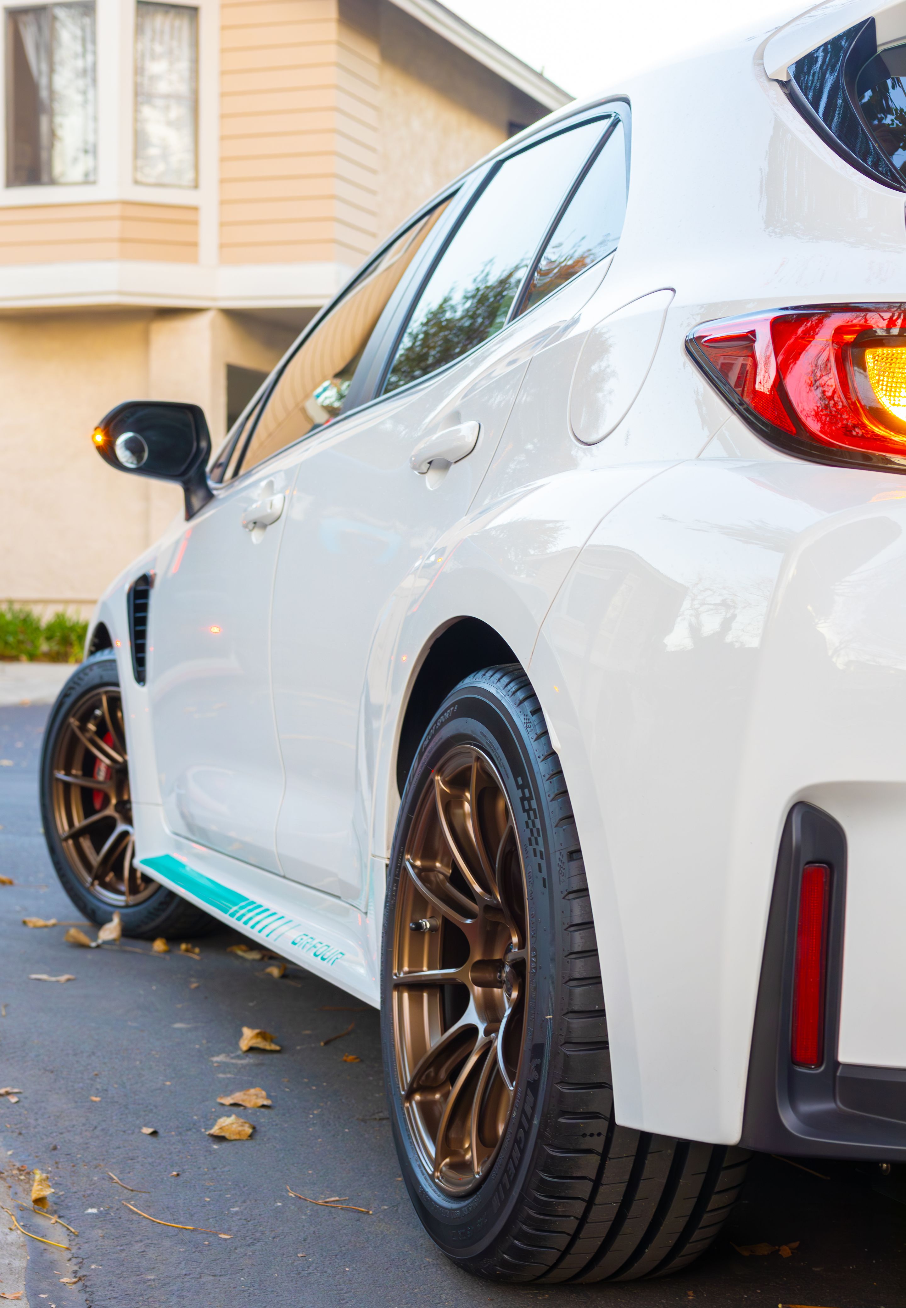 White Toyota GR Corolla with 17" SM-10RS Apex wheels in Satin Bronze