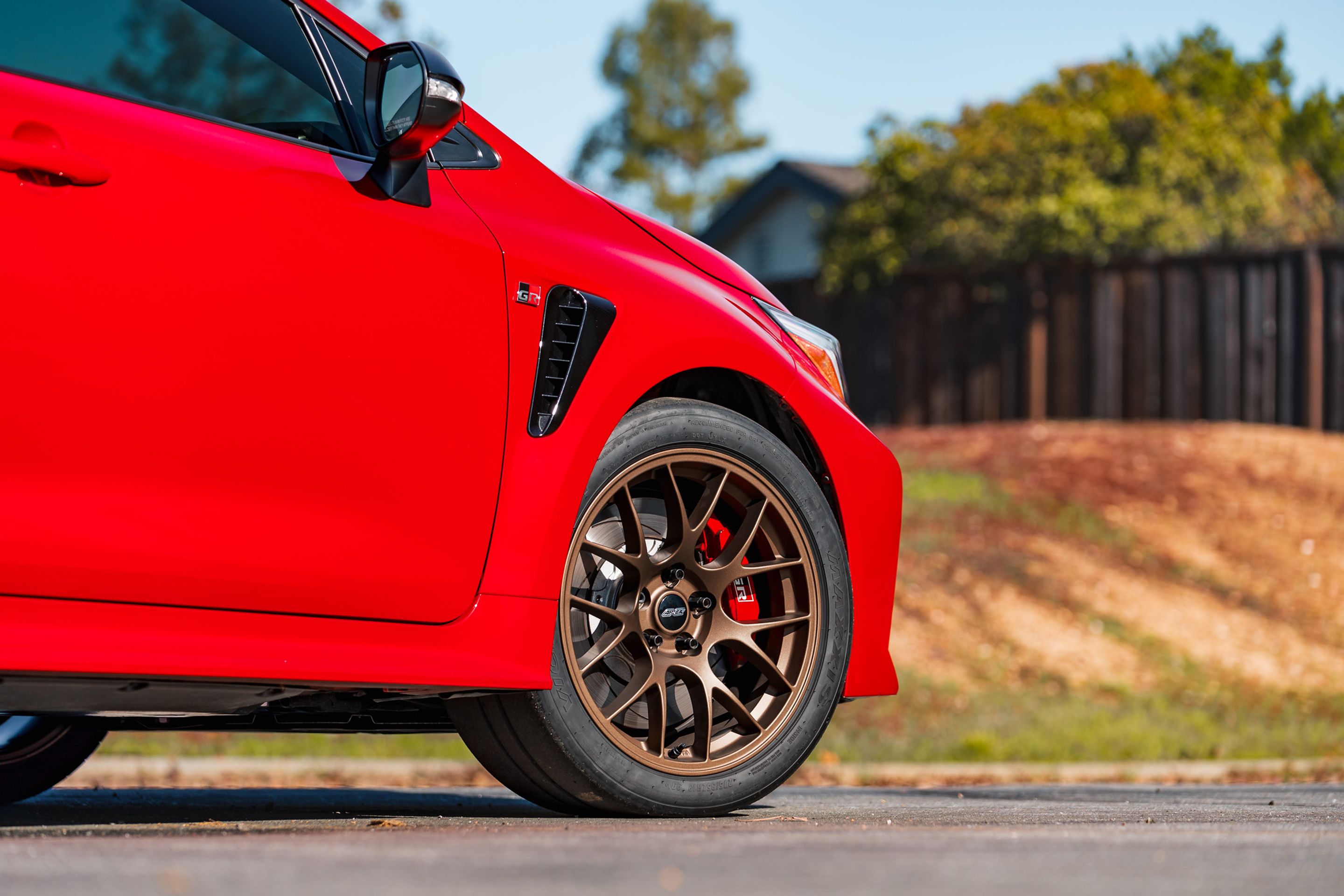 Red Toyota GR Corolla with 18" EC-7 Apex wheels in Satin Bronze
