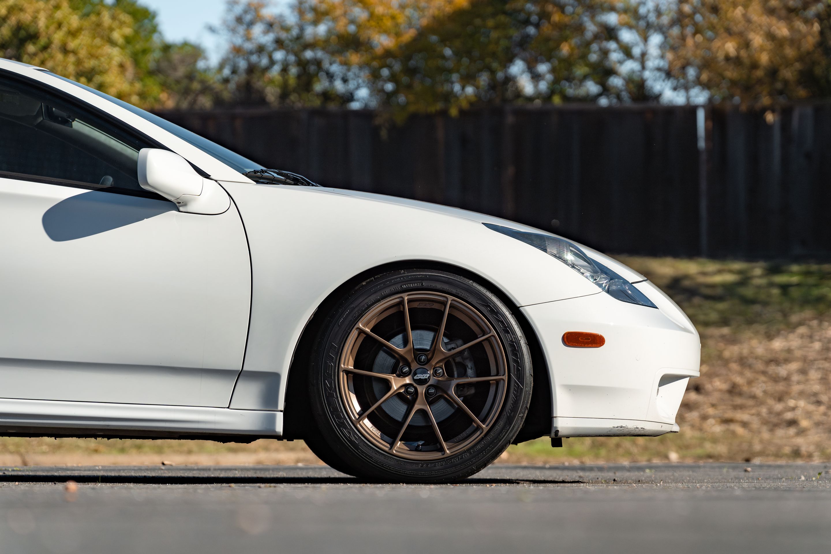White Toyota 7th Gen Celica with 17" VS-5RS Apex wheels in Satin Bronze