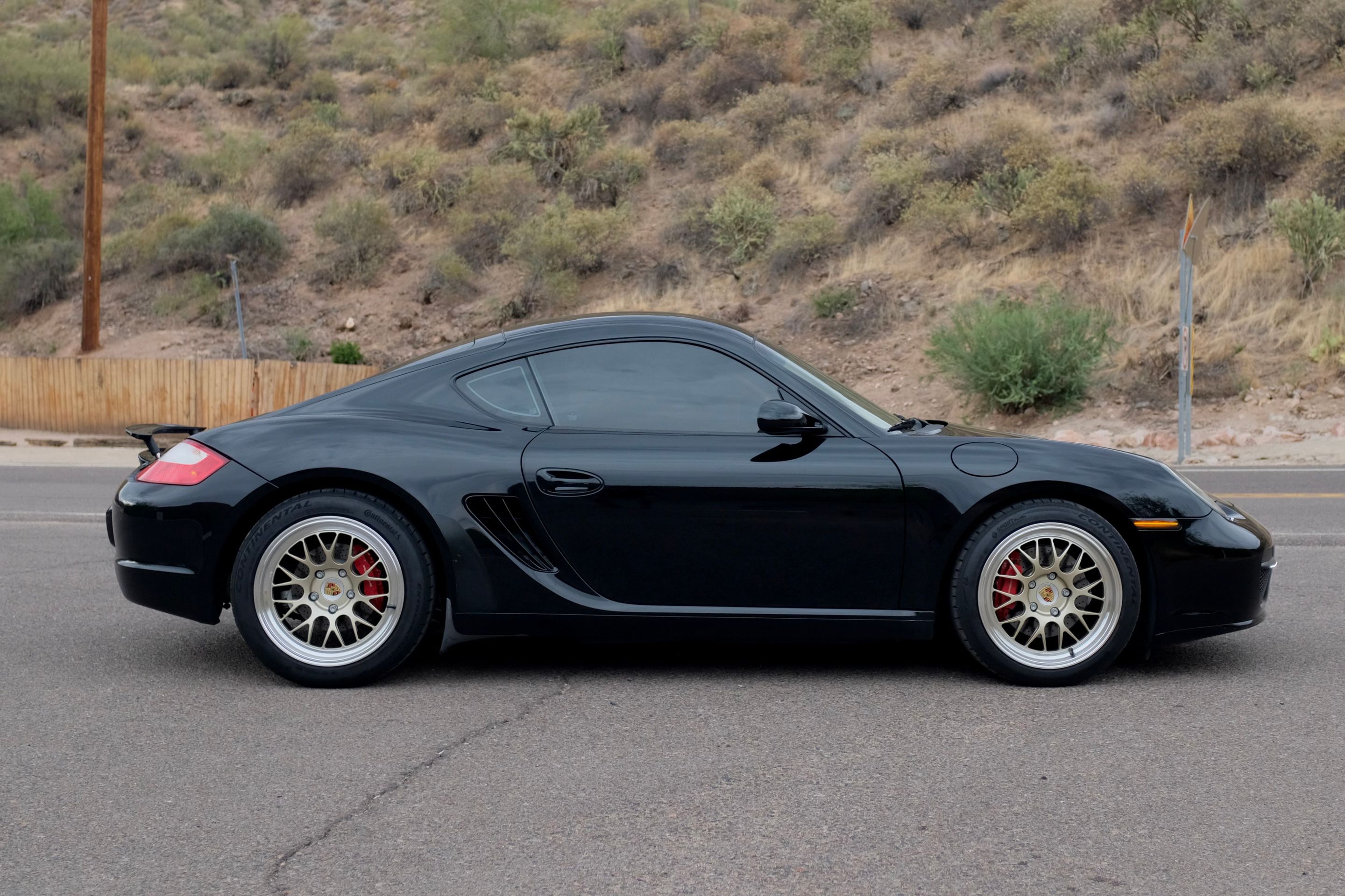 Black Porsche 987 Cayman S with 18" ML-10RT Apex wheels in Machined Lip Gloss Motorsport Gold