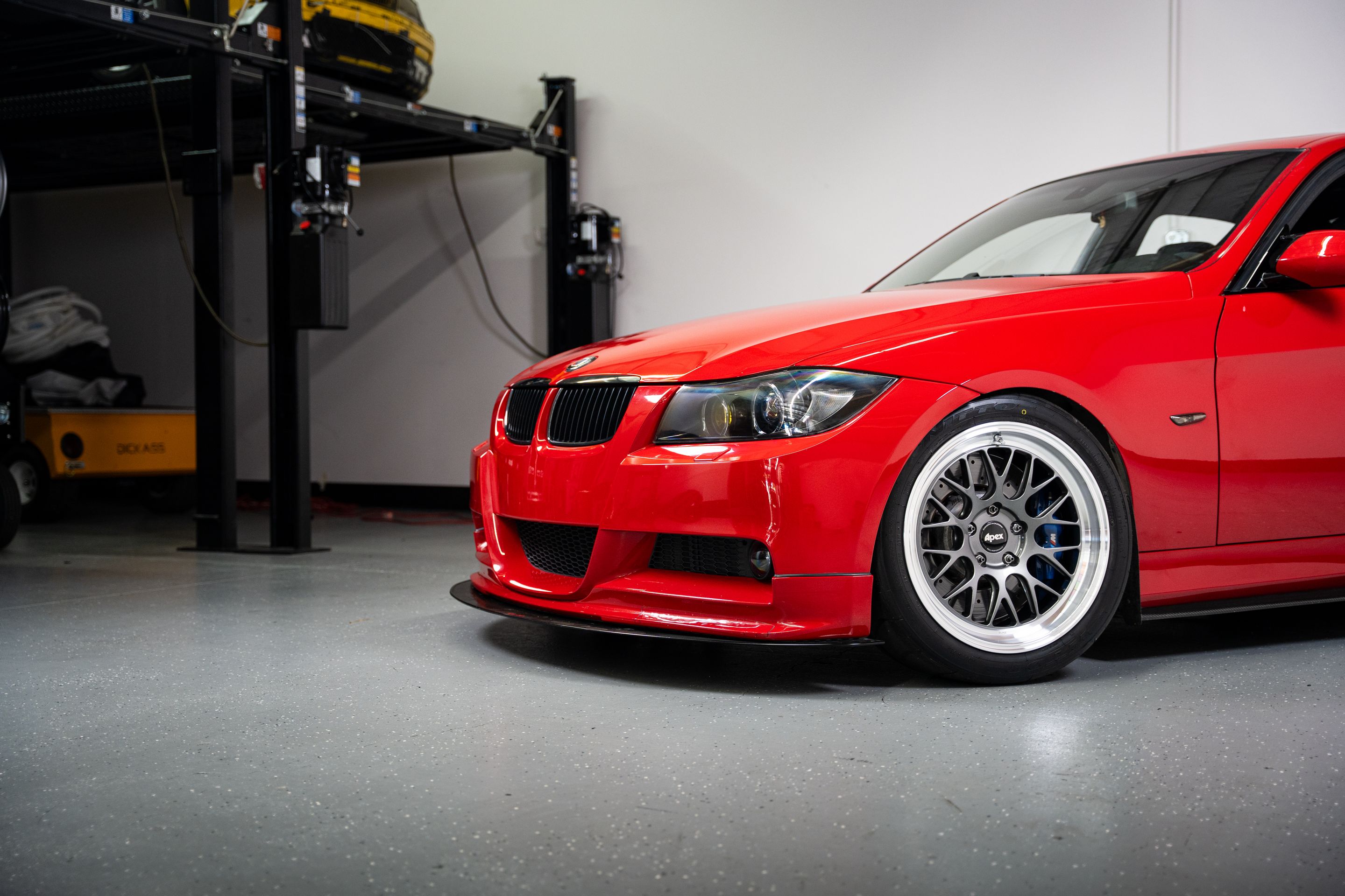 Red BMW E90 Sedan 3 Series with 18" ML-10RT Apex wheels in Machined Lip Anthracite