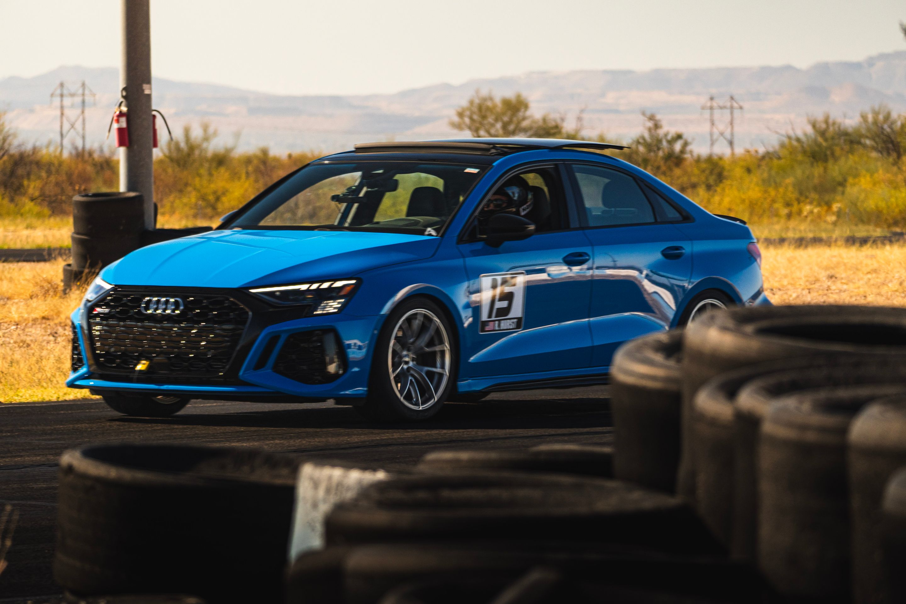 Blue Audi 8Y RS 3 with 18" VS-5RS Apex wheels in Brushed Clear