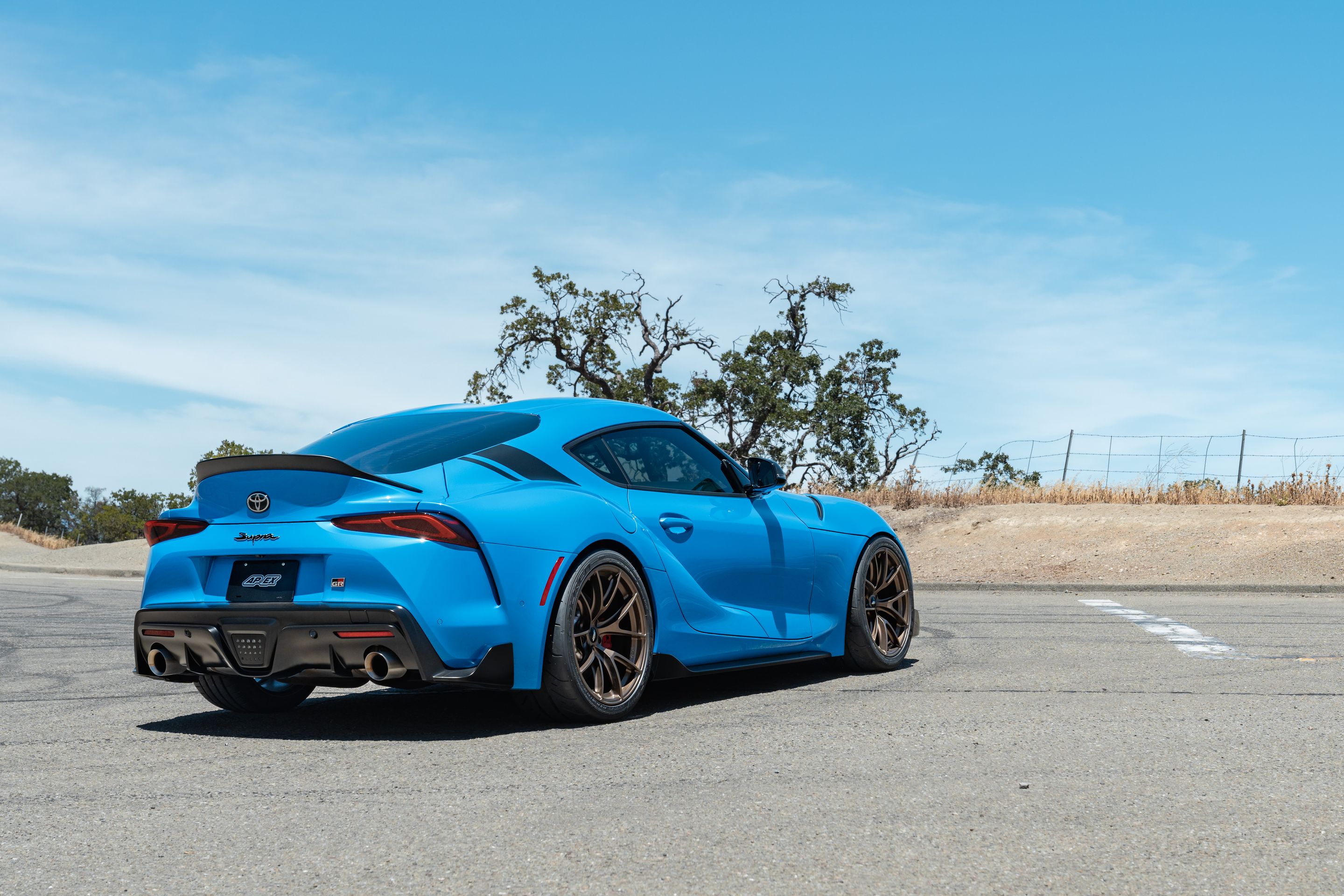 Blue Toyota GR Supra with 19" VS-5RS Apex wheels in Satin Bronze