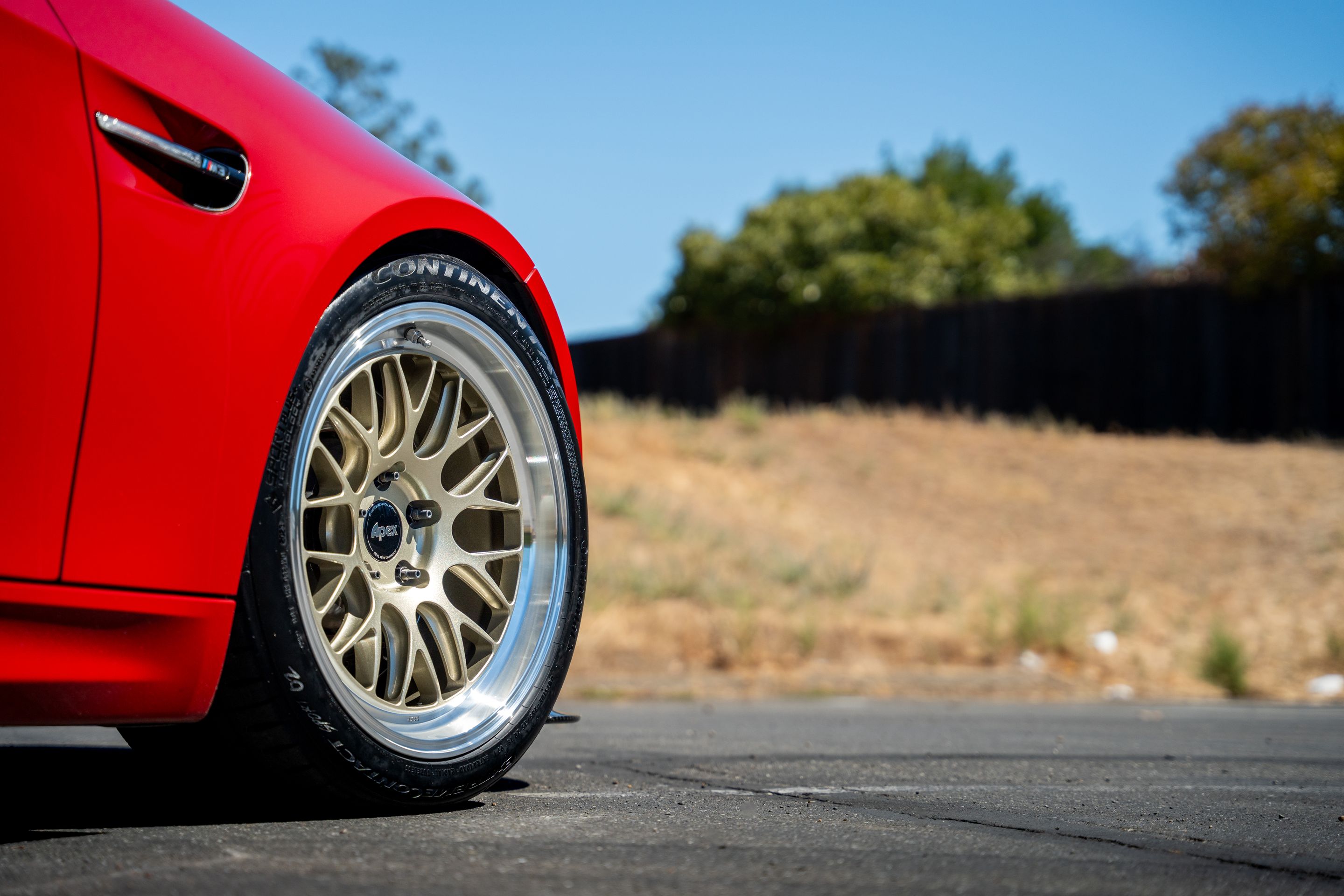Red BMW E92 Coupe M3 with 18" ML-10RT Apex wheels in Machined Lip Gloss Motorsport Gold