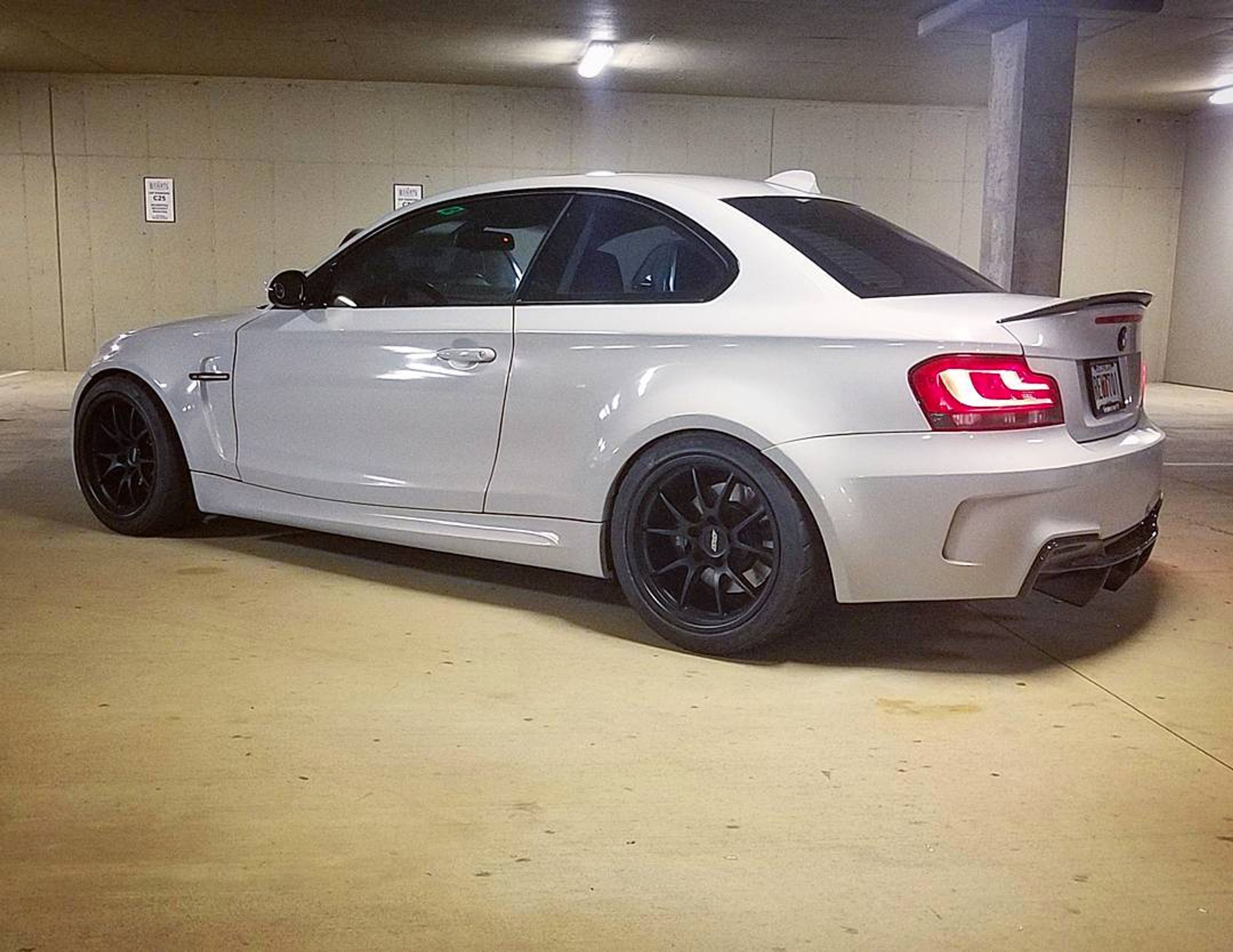 White BMW E82 1M with 18" FL-5 Apex wheels in Satin Black
