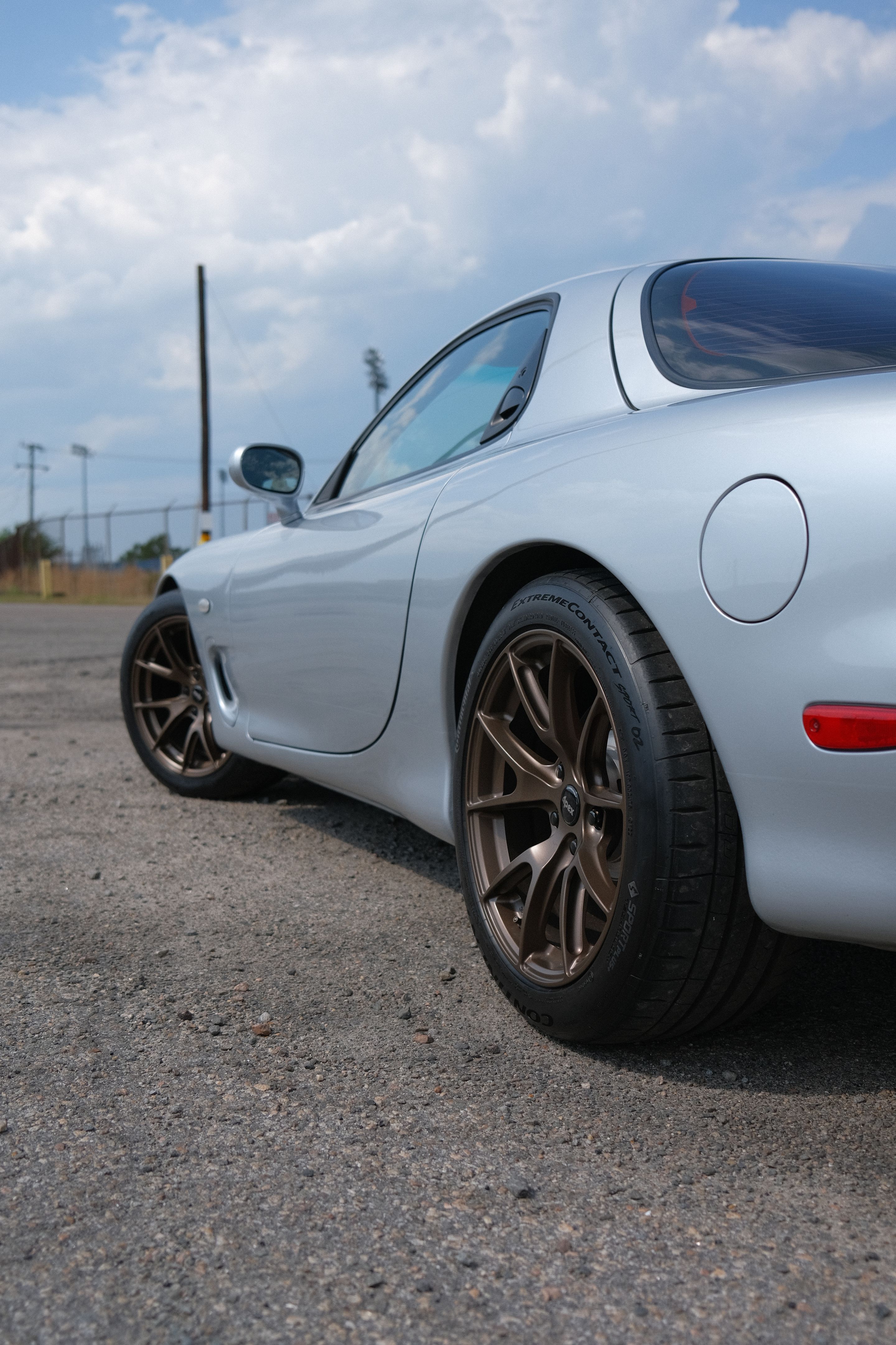 Silver Mazda FD RX-7 with 17" VS-5 Apex wheels in Satin Bronze