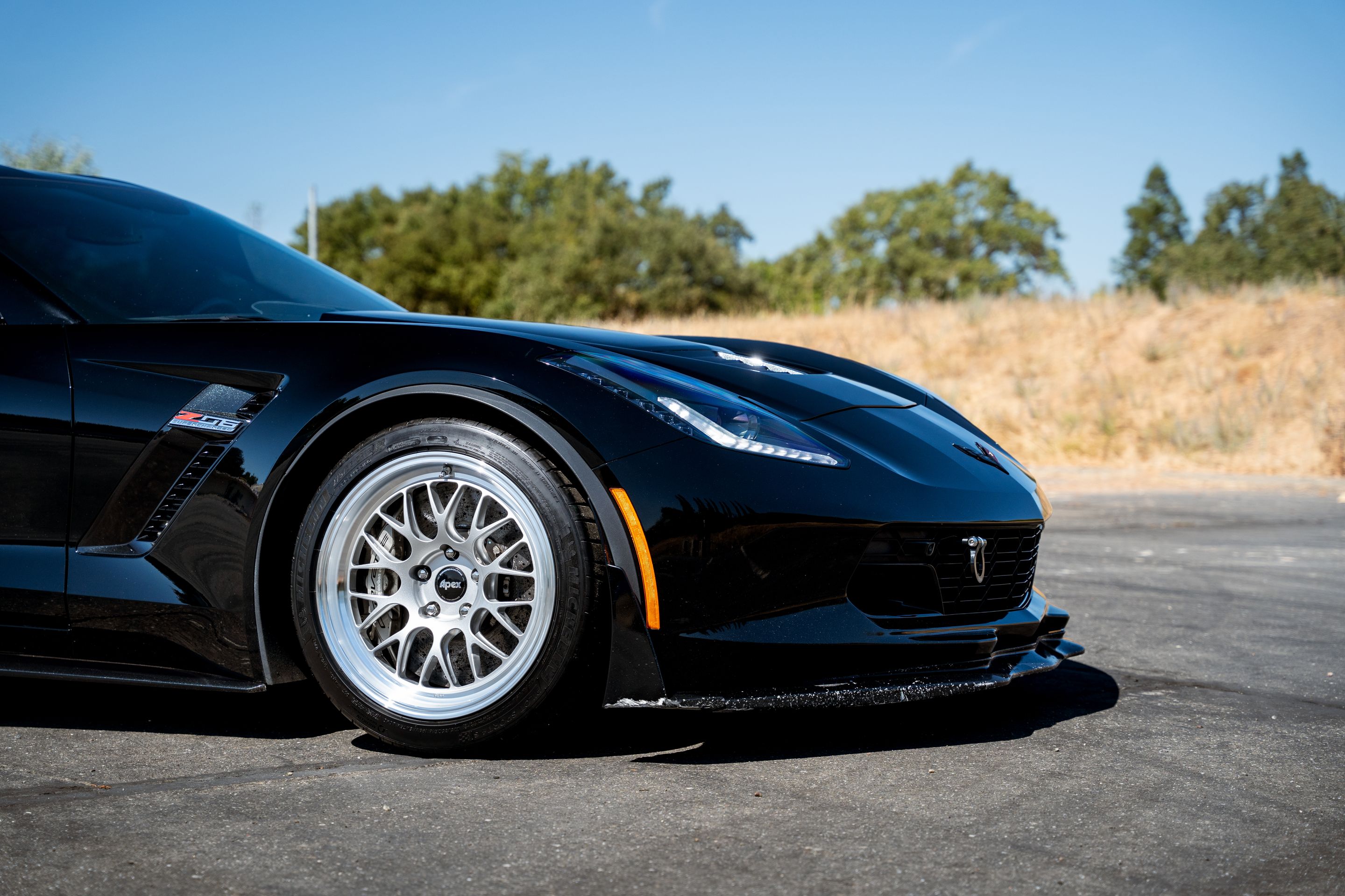 Black Chevrolet C7 Corvette Z06 with 18"/19" ML-10RT Apex wheels in Machined Lip Race Silver
