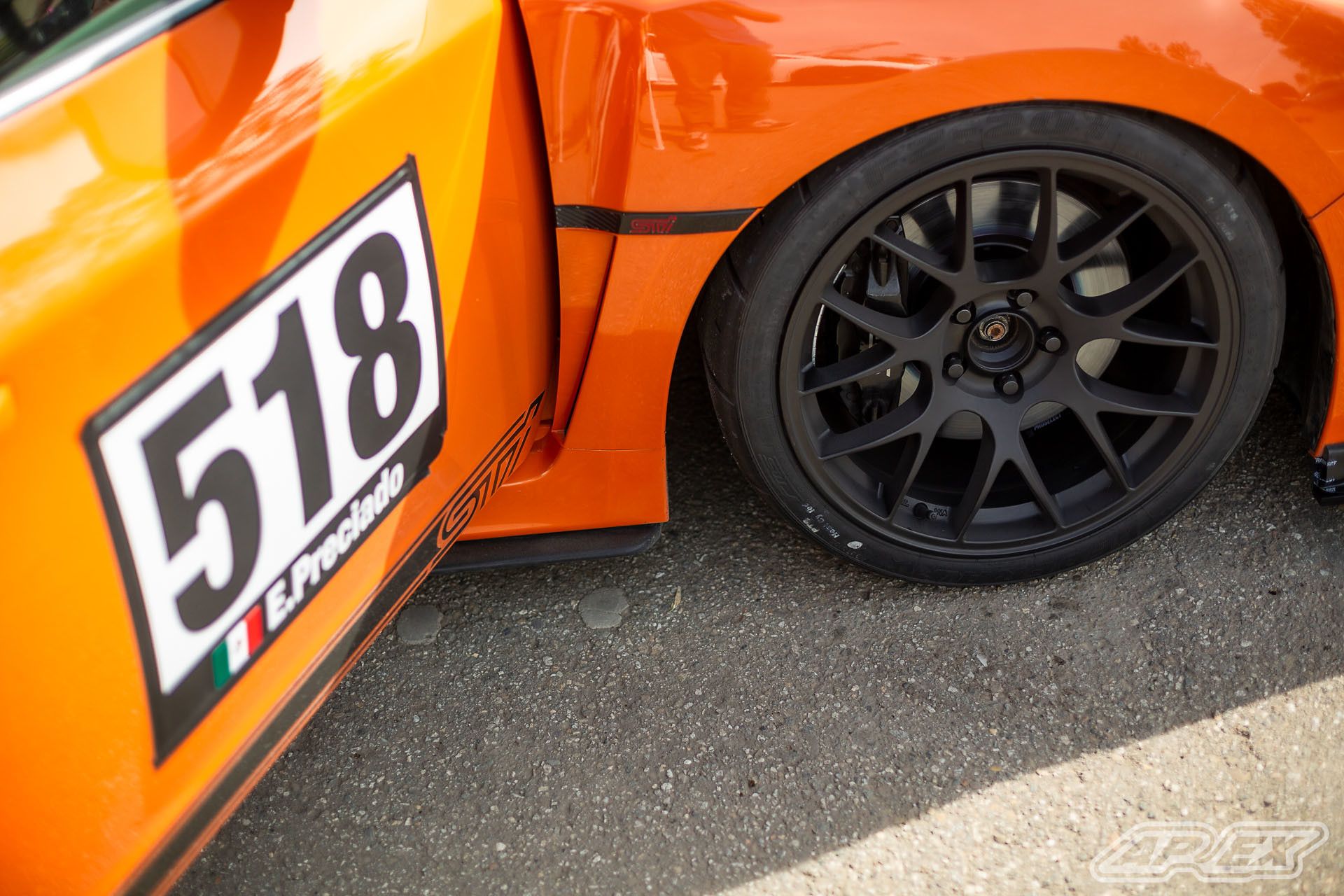 Orange Subaru GR WRX STI with 18" EC-7 Apex wheels in Satin Black