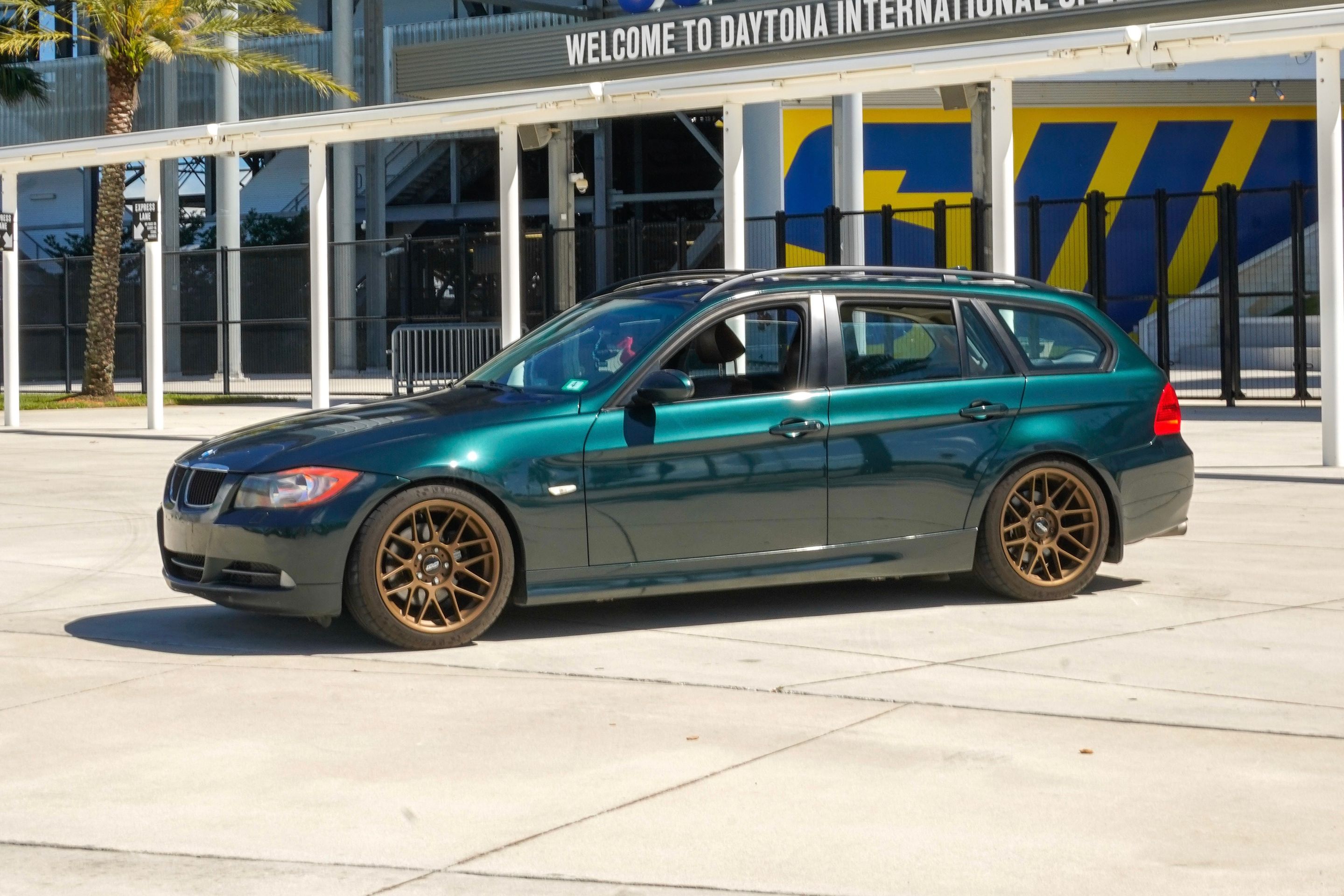 Green BMW E91 Wagon 3 Series with 18" ARC-8 Apex wheels in Satin Bronze