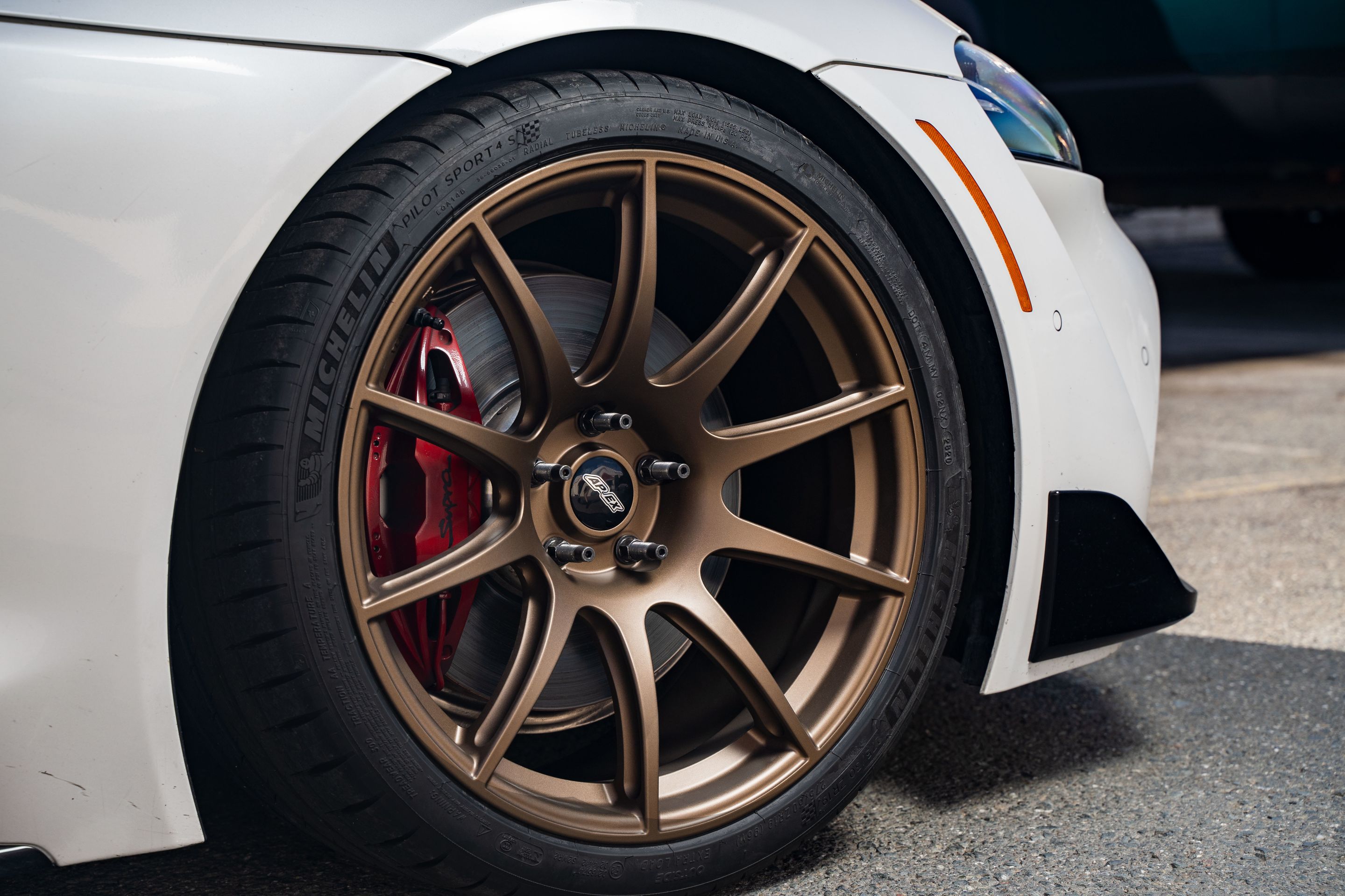 White Toyota GR Supra with 19" SM-10 Apex wheels in Satin Bronze