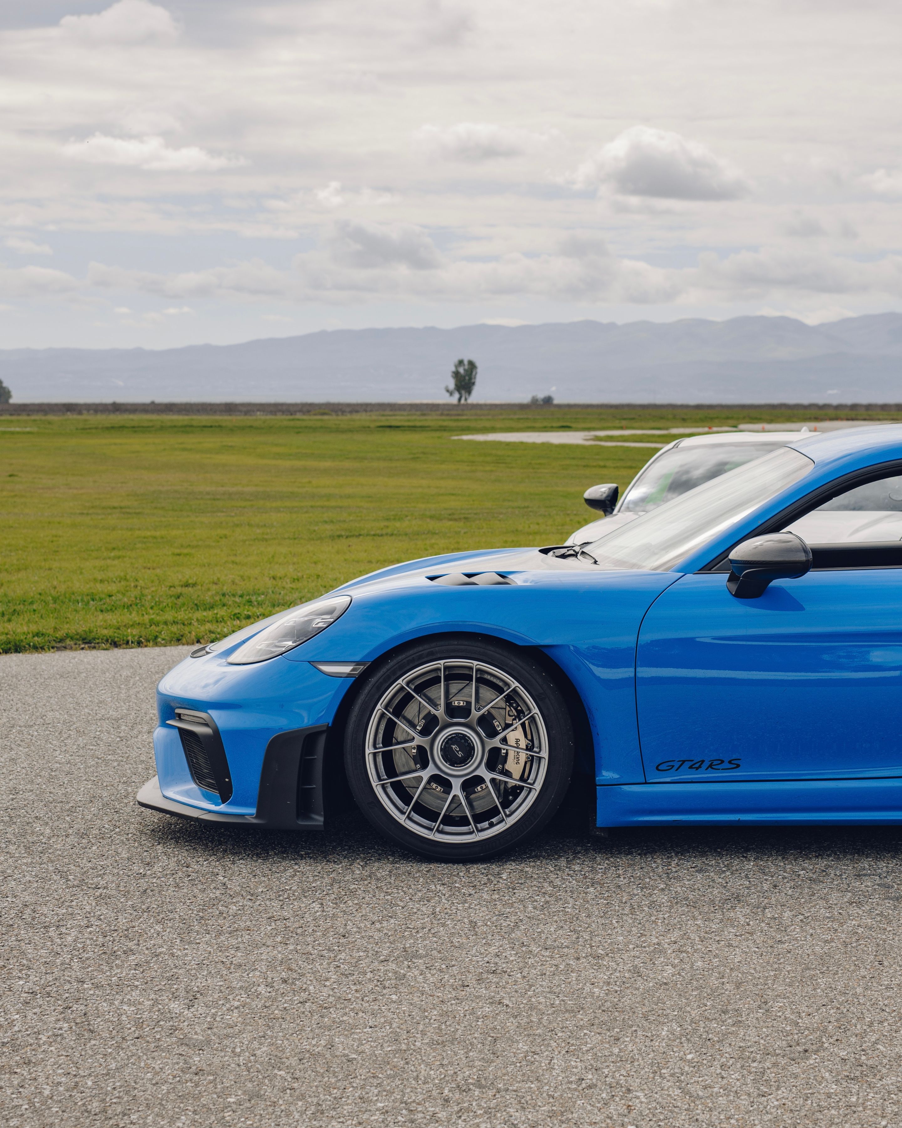 Blue Porsche 718 Cayman GT4 RS with 19" EC-7RS Apex wheels in Race Silver