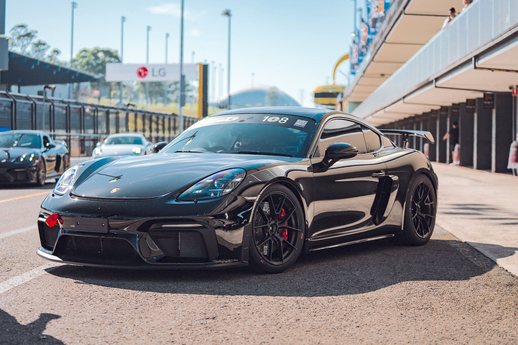 Black Porsche 718 Cayman GT4 with 19" VS-5RS Apex wheels in Satin Black