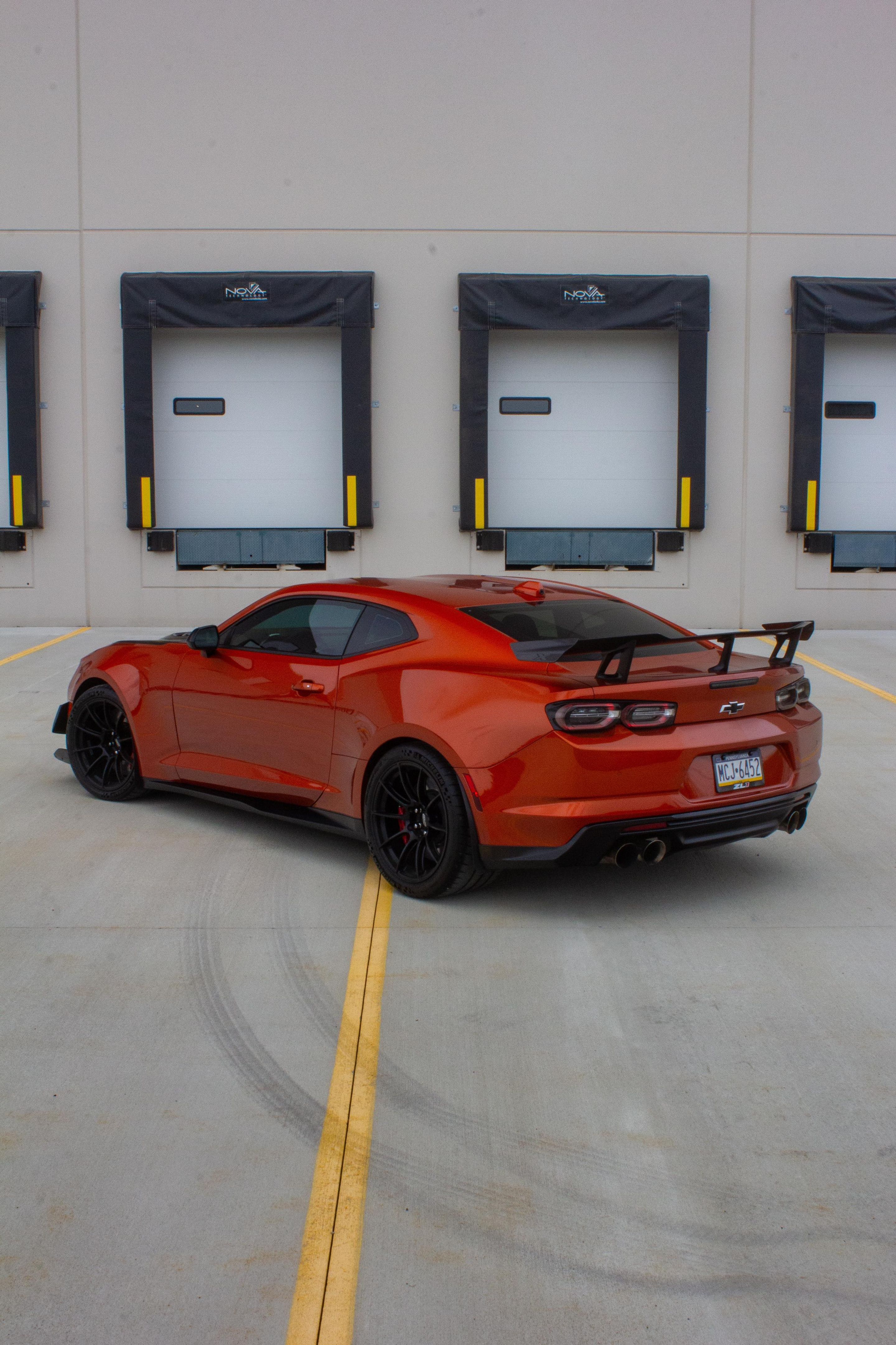 Red Chevrolet 6th Gen Camaro ZL1 1LE with 19" SM-10RS Apex wheels in Satin Black