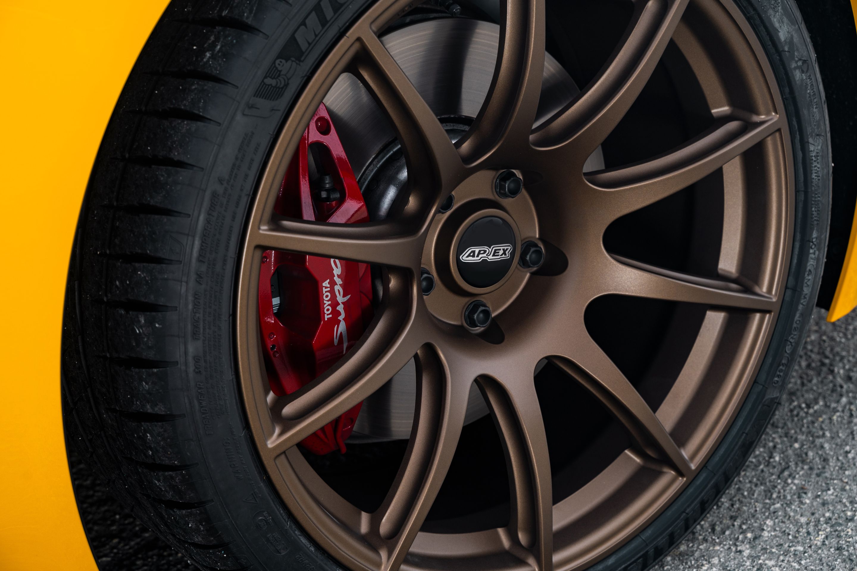 Yellow Toyota GR Supra with 19" SM-10 Apex wheels in Satin Bronze