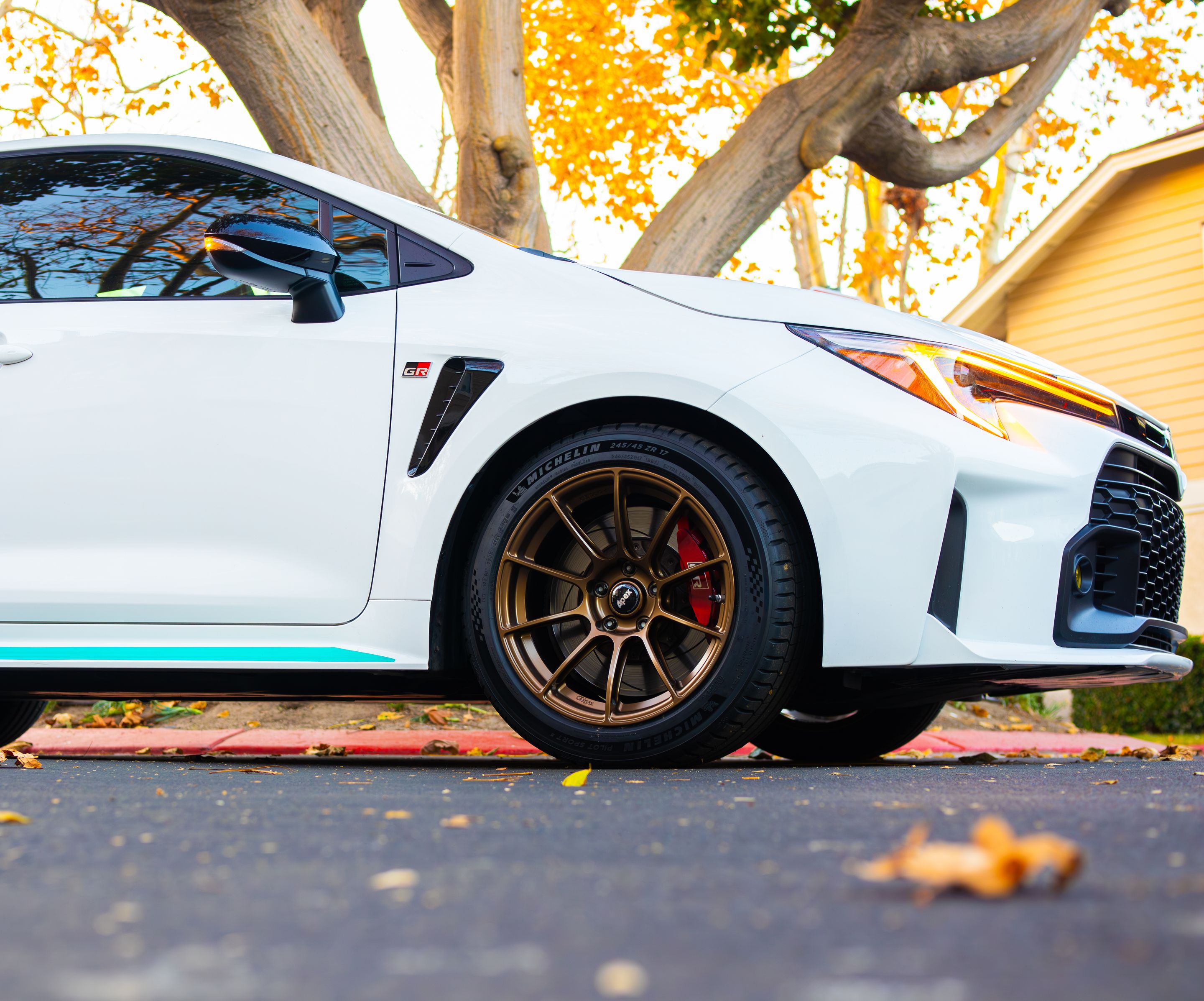 White Toyota GR Corolla with 17" SM-10RS Apex wheels in Satin Bronze